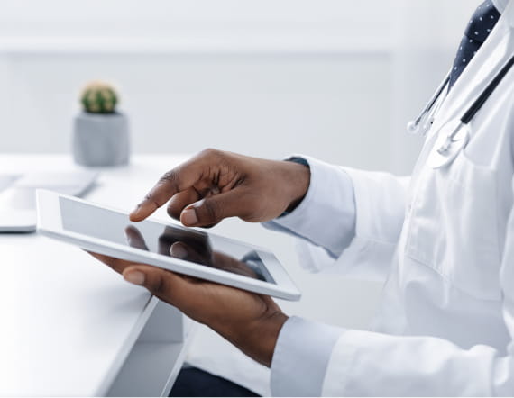 Close up of a provider using a digital tablet at the workplace.